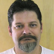 Man with short dark hair and mustache and a salt-and-pepper goatee